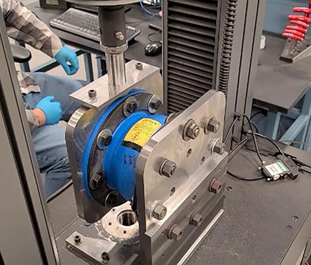 IMAGE 4: (b) Setup for spring rate test in lateral direction; (c) force-time chart for the compression spring rate test: compression rate = 1 inch/minute and compression deformation = 1 inch